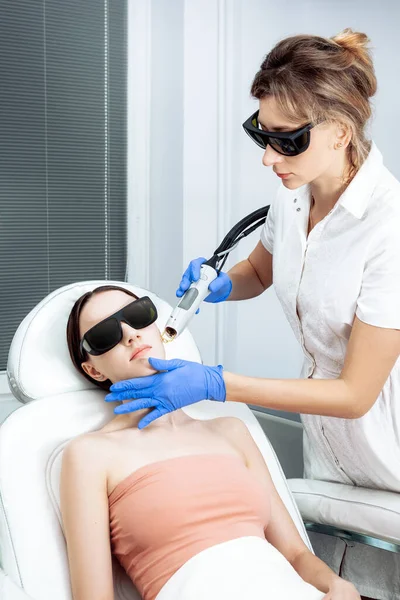 Skin Care. Young Woman Receiving Facial Beauty Treatment, Removing Pigmentation At Cosmetic Clinic. Intense Pulsed Light Therapy. IPL. Rejuvenation, Photo Facial Therapy. Anti-aging Procedures.