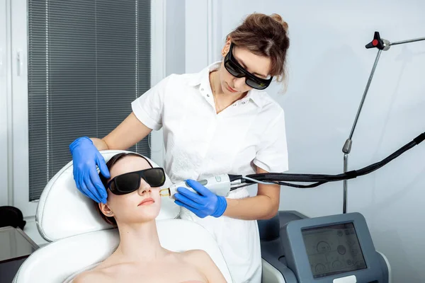 Skin Care. Young Woman Receiving Facial Beauty Treatment, Removing Pigmentation At Cosmetic Clinic. Intense Pulsed Light Therapy. IPL. Rejuvenation, Photo Facial Therapy. Anti-aging Procedures.