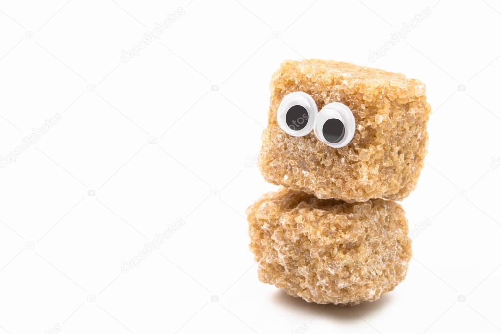 brown sugar monster with googly eyes on white background 