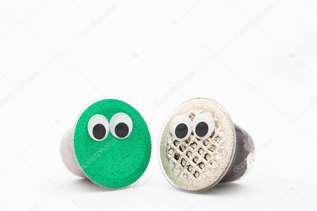 capsule coffee with googly eyes on a white background isolated 
