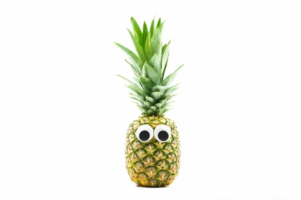 Ananas med googly ögon på vit bakgrund Stockbild