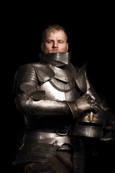 Knight in armour after battle on the black background — Stock Photo, Image