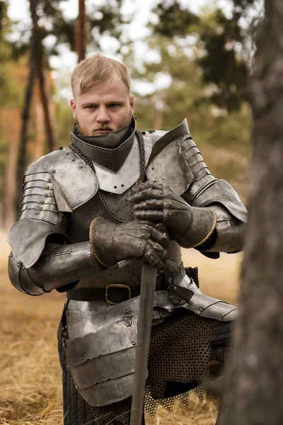 Knight in armour before battle on forest background — Stock Photo, Image