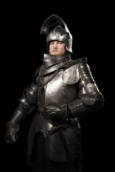 Knight in armour after battle on the black background — Stock Photo, Image