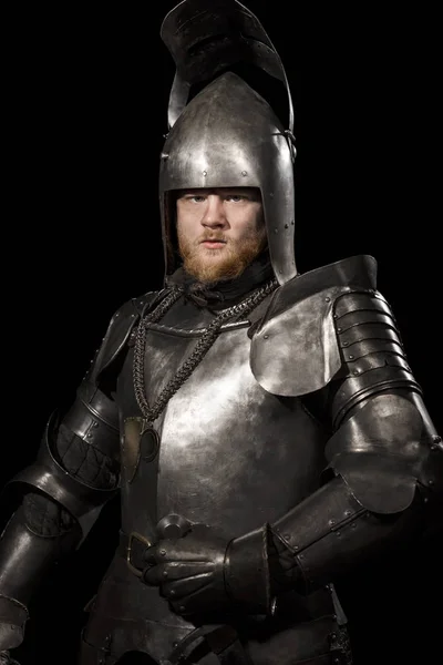 Knight in armour after battle on the black background — Stock Photo, Image
