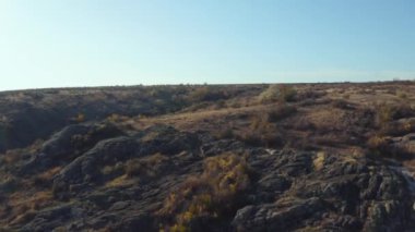 Hava görüntüsü. İHA görüntüsü. Sonbahar kanyonunda uçmak. Kayalar, su ve görkemli manzara güzel bir ışıkta. Avrupa. 4k