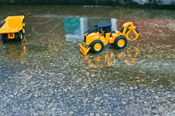 A yellow truck with fork lake under construction in a water-filled city center.