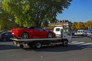 Paris, France - September 26, 2008: red Ferrari F430 spider convertible transported by ISUZU NKR K35.Y07 tow truck clipart