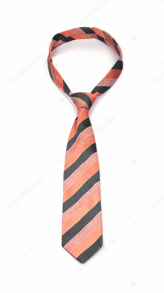 stylish tied orange and gray striped tie isolated on white background