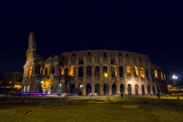 Iluminado Coliseu à noite, Roma, Itália. Bela paisagem urbana noturna adequada para fundos . — Fotografia de Stock