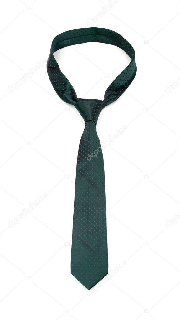 stylish tied dark green tie with dots isolated on white background