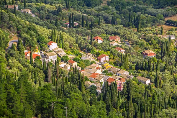 village in mountains covered with forest. View from Sokraki villas, Corfu island, Greece