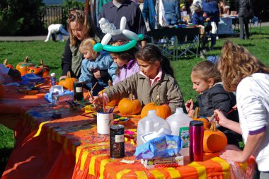 New York, ABD - Ekim 28, 2007: çocuk boya küçük Halloween pumpkins güneşli parkta 