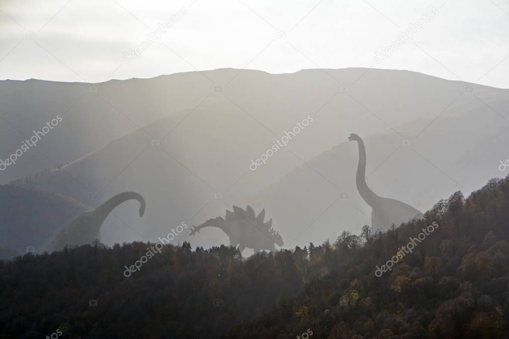 illustration of the silhouettes of three dinosaurs in a foggy slope of the covered by forest mountains lit by backlight