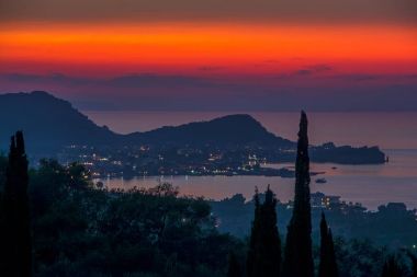 picturesque view from Karousades village to Port of Sidari at beautiful sunset over the sea. Corfu, Greece clipart