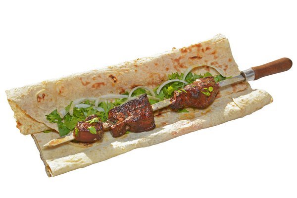 beef lung barbecue on skewer served with sliced onion and parsley on the armenian lavash (pita bread) isolated on white background