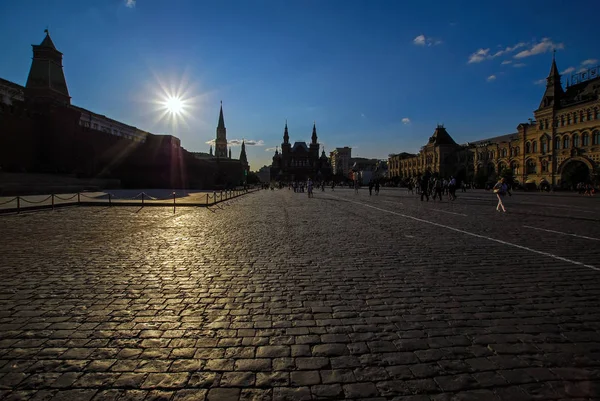 Panoramic backlit view of the Red Square, Historical Museum and GUM. Cobblestone lit by sunset sun. Available space for a text