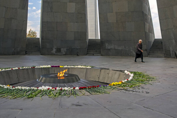 Yerevan, Armenia - November 01, 2017: elderly woman at the Tsitsernakaberd memorial monument of the Armenian Genocide