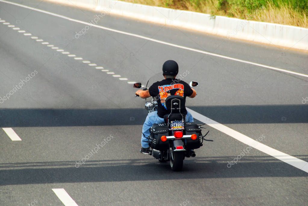 New Jersey, USA - August 09, 2012: Biker man riding american motorbike Harley Davidson on highway. Travel and transportation. Freedom of motorbike riding