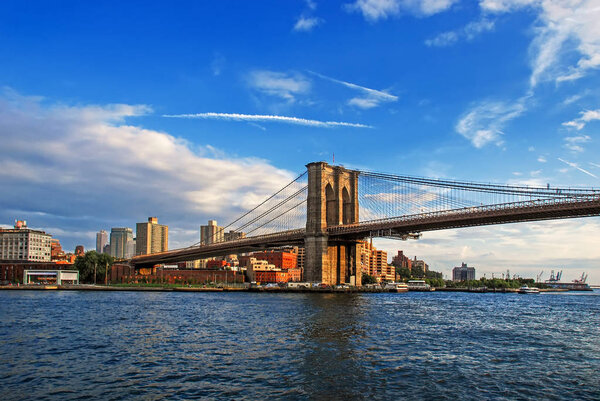Sunset view of Brooklyn Bridge with Brooklyn on background, New York, NYC, USA