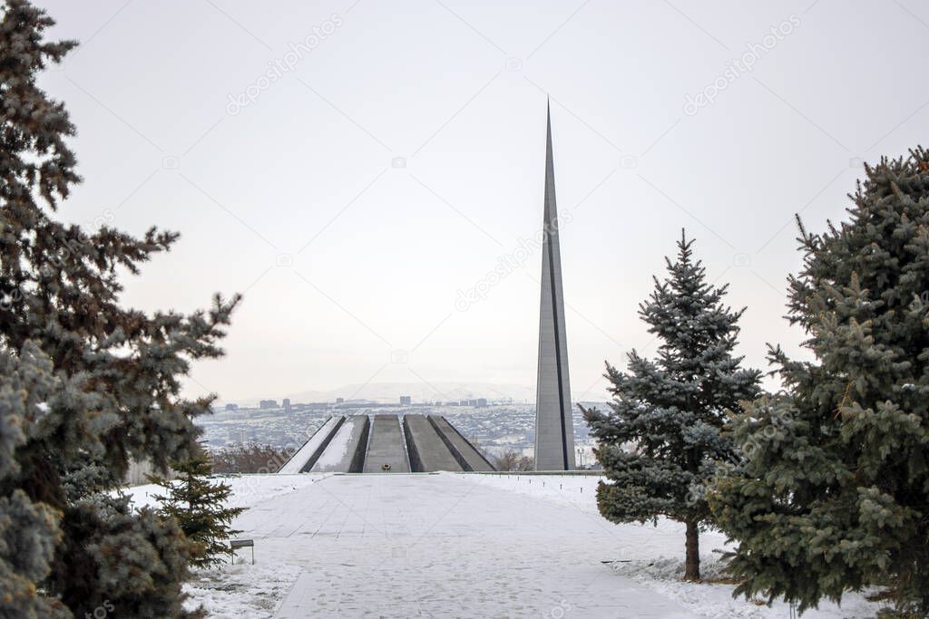 Tsitsernakaberd memorial monument of the Armenian Genocide in winter, Yerevan, Armenia. On 24th of April, 1915, 1.5 million civilian Armenians were killed by Ottoman Empire. Blurred conifer trees