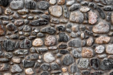 Taş duvar dokusu arka plan deseni. Betonda farklı sert taşlar olan taştan duvarlara yakın çekim.