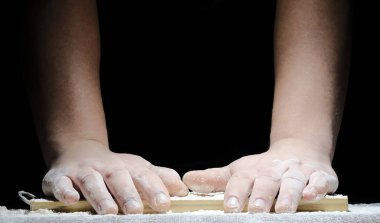 a chef with his hands in flour is preparing to cook a meal on a black background