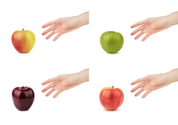 Une main féminine prend une pomme rouge isolée sur un fond blanc . — Photo
