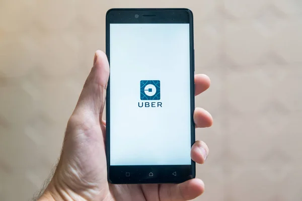 Uber application logo on smartphone — Stock Photo, Image
