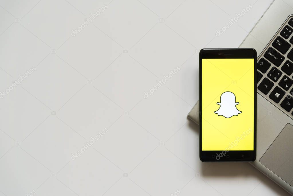 Bratislava, Slovakia, April 28, 2017: Snapchat logo on smartphone screen placed on laptop keyboard. Empty place to write information.