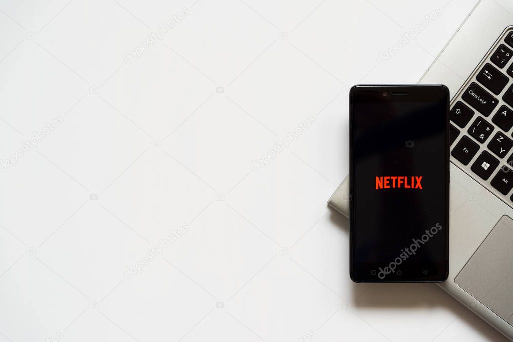 Bratislava, Slovakia, April 28, 2017: Netflix logo on smartphone screen placed on laptop keyboard. Empty place to write information.