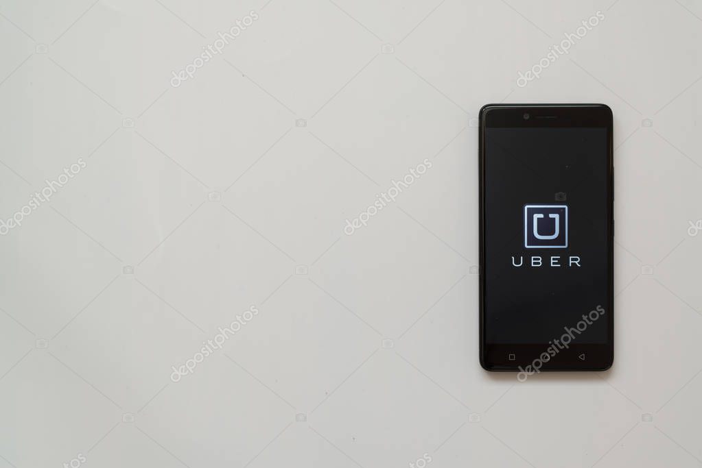 Los Angeles, USA, july 13, 2017: Uber logo on smartphone screen on white background.