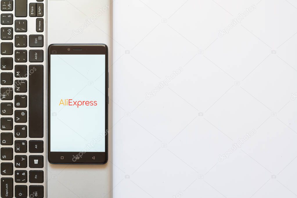 Los Angeles, USA, july 18, 2017: Aliexpress logo on smartphone screen placed on the laptop on white background.