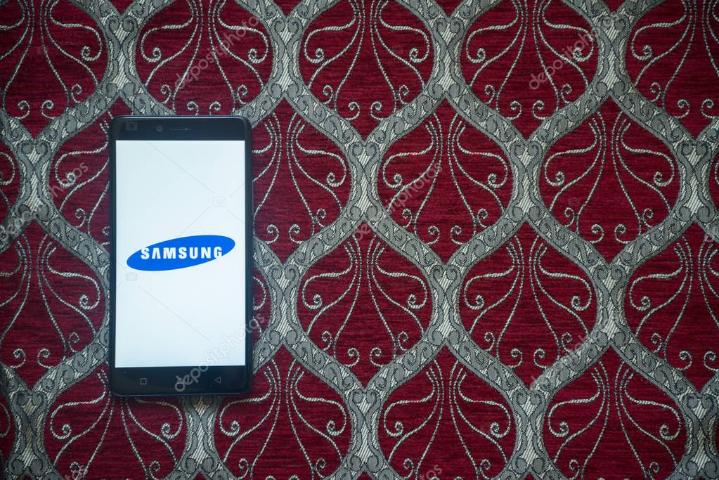 Los Angeles, USA, october 14, 2017: Samsung logo on smartphone screen on red background.