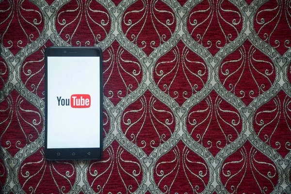 YouTube logo üstünde smartphone perde — Stok fotoğraf