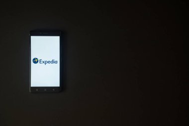 Expedia logo on smartphone screen on black background