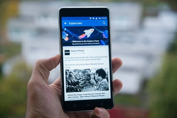Facebook explore feed on mobile phone — Stock Photo, Image
