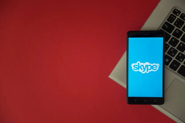 Логотип Skype на экране смартфона размещен на клавиатуре ноутбука . — стоковое фото