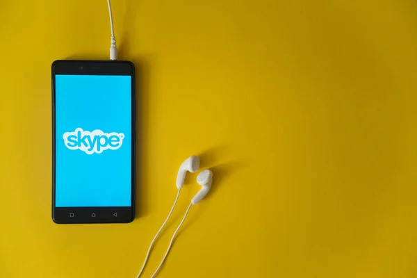 Logotipo de Skype en la pantalla del teléfono inteligente sobre fondo amarillo — Foto de Stock