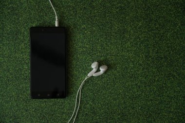 Smartphone yeşil çim zemin üzerine.