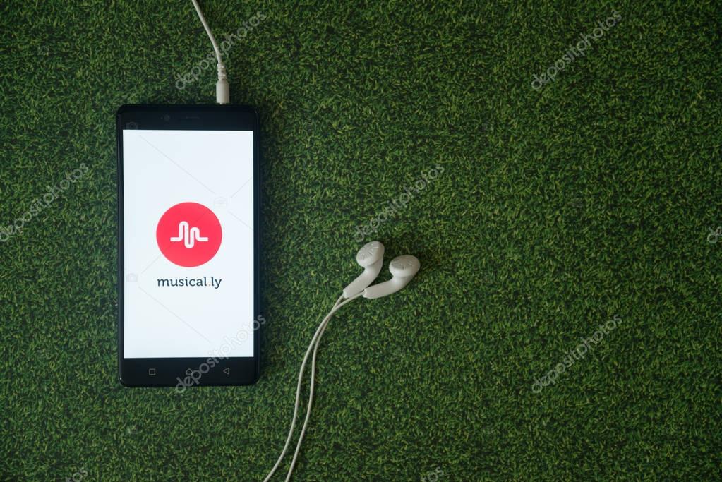 Los Angeles, USA, october 23, 2017: Musical.ly logo on smartphone screen on green grass background.