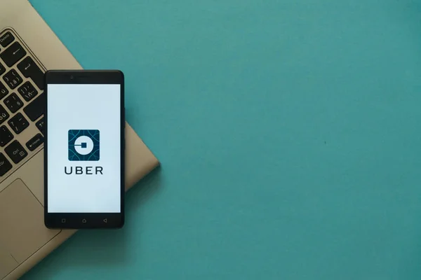 Logo Uber pada smartphone ditempatkan pada keyboard laptop . — Stok Foto