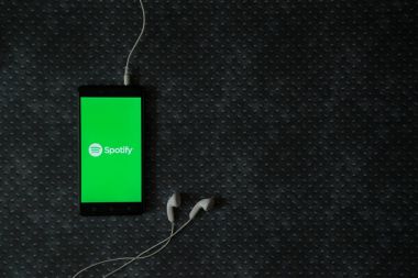 Metal plaka arka plan ekranda smartphone logosuna spotify.