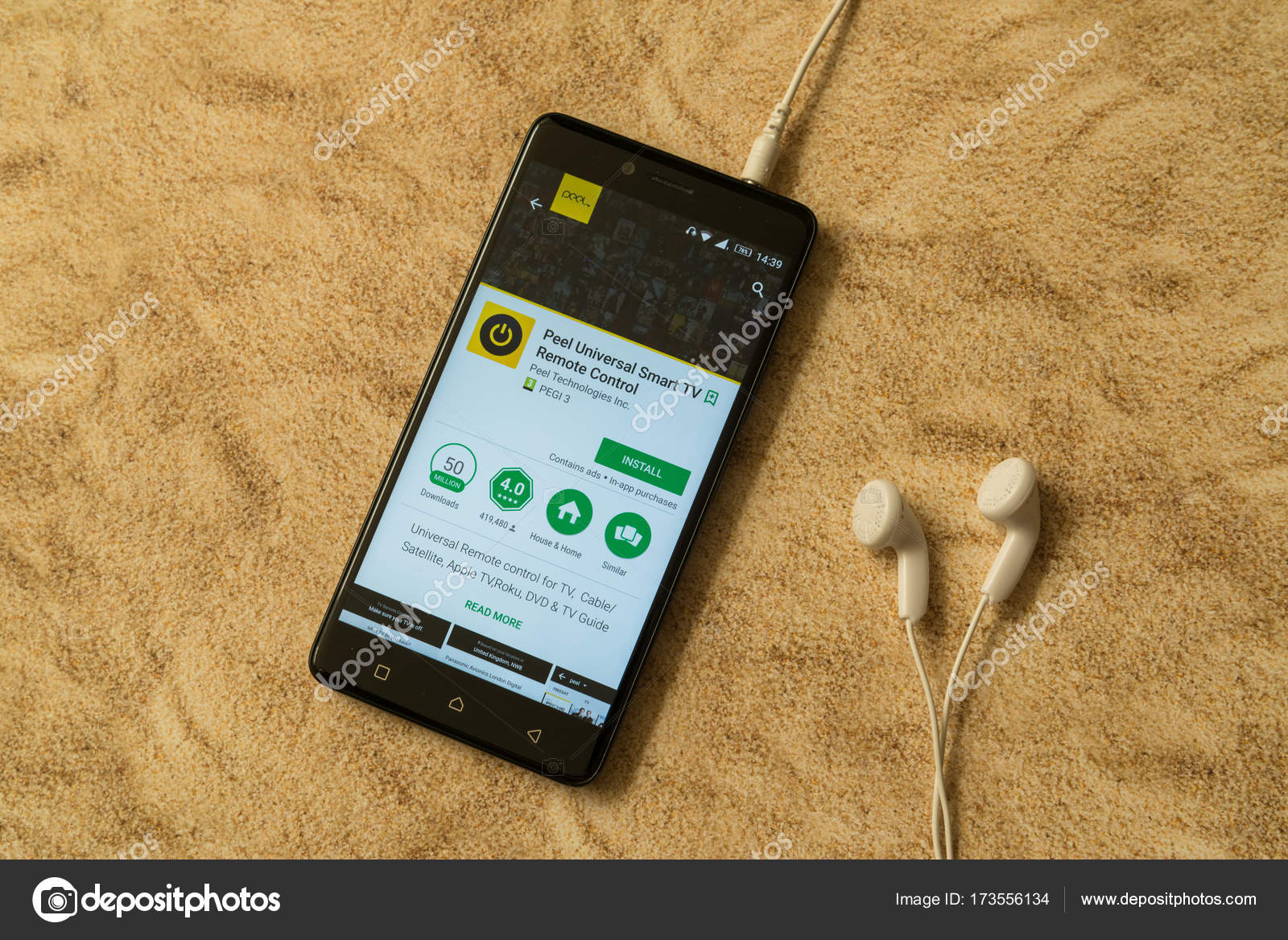 Peel universal smart tv remote control application in google play store on sandy background and