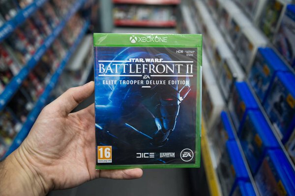 Bratislava, Slovakia, december 1, 2017: Man holding Star Wars Battlefront II videogame on Microsoft XBOX One console in store