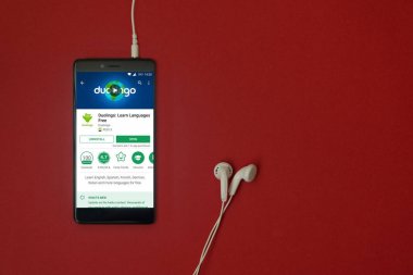 Los Angeles, 11 Ocak 2018: Smartphone Uygulama google oyun takılı kulaklık ile kırmızı zemin üzerine depolamak ve uzay kopyalamak Duolingo ile