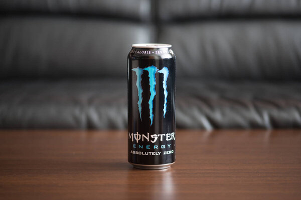 Bratislava, Slovakia, february 4, 2018: Monster energy drink on wooden table with black skin background