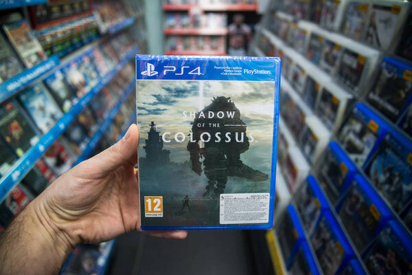 Bratislava, Slovakia, february 12, 2018: Man holding Shadow of the Colossus videogame on Sony Playstation 4 console in store