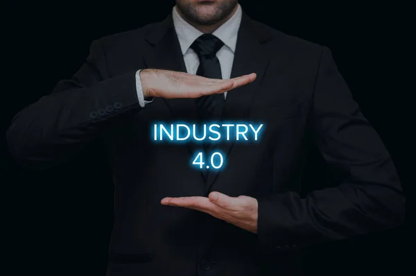 Industry 4.0 concept with businessman on black background