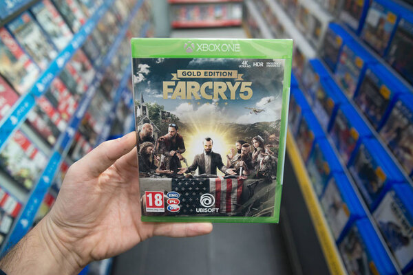 Bratislava, Slovakia, march 28, 2018: Man holding Far Cry 5 videogame on Microsoft XBOX One console in store